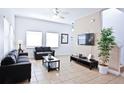 Living room with two sofas, a coffee table, and a large TV at 4577 Alberto Cir, Kissimmee, FL 34746