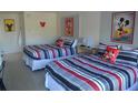 Bedroom with two double beds and Mickey Mouse decor at 5245 W Irlo Bronson Memorial Hwy # 115, Kissimmee, FL 34746