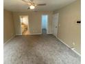 Main bedroom with ensuite bathroom, walk-in closet, and carpeted flooring at 6180 Hemlock Rd, Ocala, FL 34472