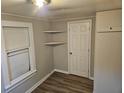 Bright bedroom featuring wood-look floors and ample closet space at 721 Langston Ave, Haines City, FL 33844