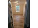 Simple bedroom with wood-look floors and a window at 721 Langston Ave, Haines City, FL 33844