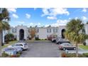 Elevated view of the community entrance with lush landscaping and parked cars at 1006 Plantation Dr # F12, Kissimmee, FL 34741