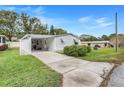 Front view of a single-story home with a carport and driveway at 1737 Stacey Dr, Mount Dora, FL 32757