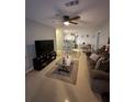 Open living room with view of kitchen and dining area at 4320 S Kirkman Rd # 1513, Orlando, FL 32811