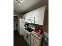 Well-equipped kitchen with white cabinetry, granite counters, and modern appliances at 4368 S Kirkman Rd # 201, Orlando, FL 32811