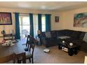 Open-concept living and dining area with sliding glass doors to a balcony at 508 Orange Dr # 20, Altamonte Springs, FL 32701