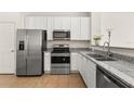 Bright and clean kitchen featuring stainless steel appliances and granite countertops at 5315 Paradise Cay Cir, Kissimmee, FL 34746