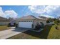 Side view of the house, highlighting the solar panels on the roof at 622 Parakeet Ct, Kissimmee, FL 34759