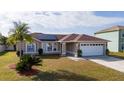 Elevated view of the home's front exterior, showcasing its landscaping at 622 Parakeet Ct, Kissimmee, FL 34759