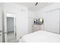 Bedroom with white walls, wood-look flooring, and view of en suite bathroom at 733 Calabria Ave, Davenport, FL 33897
