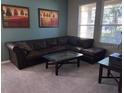 Living room with sectional sofa and large windows at 842 Sussex Dr, Davenport, FL 33896