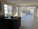 Open-concept living area with view of pool and backyard, wood-look tile floor at 1396 Peaceful Nature Way # 1396, Clermont, FL 34714
