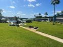 Community pool area with lush landscaping and walkways at 1600 W Lake Parker Dr # B23, Lakeland, FL 33805
