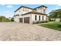Two-story home with a paver driveway and landscaped yard at 3167 Whisper Wind Dr, St Cloud, FL 34771