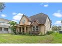 Two-story home with a stone and siding facade, copper gutters, and a covered front porch at 3305 Cat Brier Trl, Harmony, FL 34773