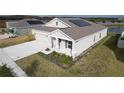 One-story house with solar panels and a two-car garage, aerial view at 420 Watusi Way, St Cloud, FL 34772