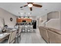 Open concept kitchen and dining area with island at 4735 Terrasonesta Dr, Davenport, FL 33837