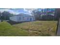 Spacious backyard with a large grassy area at 605 Raven Ct, Kissimmee, FL 34759