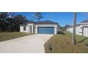 Newly built home with a teal garage door and concrete driveway at 605 Raven Ct, Kissimmee, FL 34759