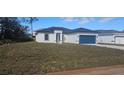New construction home with a large grassy yard at 605 Raven Ct, Kissimmee, FL 34759