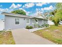 Gray house with a paved driveway and a neatly landscaped yard at 723 Florida Pkwy, Kissimmee, FL 34743