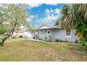 Gray house with white trim and a well-maintained lawn at 723 Florida Pkwy, Kissimmee, FL 34743