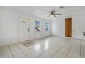 Bright living room with tile floors and a ceiling fan at 723 Florida Pkwy, Kissimmee, FL 34743