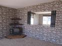 Living room with stone wall accents and a fireplace at 8286 County Road 109B, Lady Lake, FL 32159