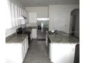 Modern kitchen with stainless steel appliances and granite countertops at 1366 Yellow Finch Dr, Davenport, FL 33837