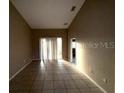 Bright and spacious living room with tile flooring and access to a back patio at 2642 Rutledge Ct, Winter Haven, FL 33884