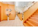Bright hallway with tiled floors and staircase to upper level at 2801 S Granada Blvd, Kissimmee, FL 34746