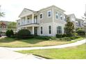 Two-story house with light beige siding, balcony, and landscaping at 2900 Windmill Dr, Kissimmee, FL 34741