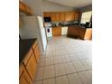 Spacious kitchen with light wood cabinets and tile flooring at 308 Coventry Estates Blvd, Deltona, FL 32725