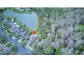 Aerial view of a house near a lake in a quiet residential neighborhood at 334 Bell Tower Xing W, Poinciana, FL 34759