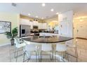 Modern kitchen with granite countertops, stainless steel appliances, and breakfast bar at 4191 Oaktree Drive, Davenport, FL 33837