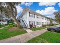 Light blue building with grey stairs and landscaping; ample parking is visible at 4860 Conway Rd # 56, Orlando, FL 32812