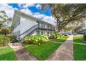 Two-story building with grey stairs and balconies. Landscaped grounds with walkways at 4860 Conway Rd # 56, Orlando, FL 32812