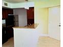 Kitchen features granite countertops and dark wood cabinets at 5124 Conroy Rd # 635, Orlando, FL 32811