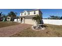 Two-story house with a brick driveway and a landscaped lawn at 640 Spanish Pine Rd, Davenport, FL 33837