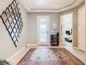 Bright entryway with decorative mirror and rug at 681 San Joaquin Rd, Poinciana, FL 34759