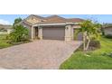 Brick paver driveway leading to a two-car garage at 681 San Joaquin Rd, Poinciana, FL 34759