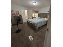 Primary bedroom with carpeted floors and a full bed at 8185 County Road 109, Lady Lake, FL 32159