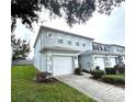 Two-story townhome with attached garage and landscaped lawn at 10786 Savannah Wood Dr # 126, Orlando, FL 32832