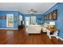 Living room with hardwood floors, white couch and blue walls at 453 Water St, Kissimmee, FL 34747