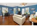 Bright living room with hardwood floors, comfy seating, and Mickey Mouse decor at 453 Water St, Kissimmee, FL 34747