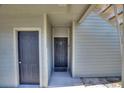 Exterior view of a building entrance with two doors and a staircase at 5980 Westgate Dr # Apt 103, Orlando, FL 32835
