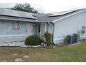 House exterior showcasing solar panels and landscaping at 10407 Sw 85Th Ct, Ocala, FL 34481