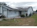 Front view of a single-story house with solar panels at 10407 Sw 85Th Ct, Ocala, FL 34481
