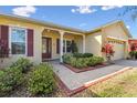 House exterior with landscaped yard and brick walkway at 256 New River Dr, Poinciana, FL 34759