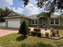 House with brick driveway and well-maintained landscaping at 2605 Coldstream Ct, Kissimmee, FL 34743